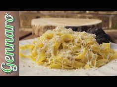 a white plate topped with pasta covered in cheese