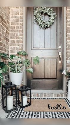 the front door is decorated with plants and candles