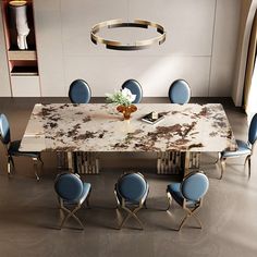 a dining room table with blue chairs and a white marble top