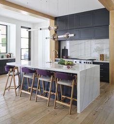 a kitchen with an island and bar stools