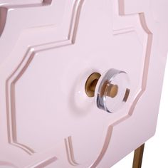 a close up of a door handle on a pink cabinet