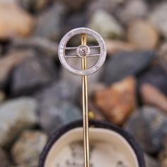 This antique diamond circle stick pin features a platinum topped open circle with an old European cut diamond bezel set at the center. It is crafted in 14k yellow gold. Art Deco Jewelry With Single Cut Round Diamonds, Art Deco Jewelry With Single Round Diamond, Art Deco Single Diamond Round Jewelry, Art Deco Round Single Diamond Jewelry, Circle Diamond, European Cut Diamonds, Stick Pins, Antique Diamond, Bezel Diamond