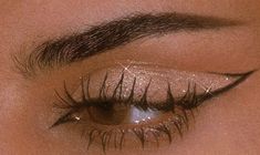 a woman's eye with long lashes and glitters on her eyeshade