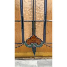 an art nouveau stained glass window on the side of a building