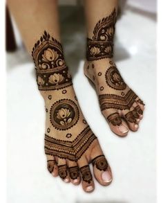 the feet are decorated with henna designs