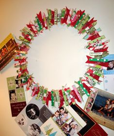 a circle made out of many different pieces of paper and some pictures on the wall