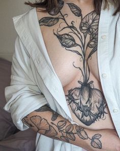 a woman with tattoos on her chest and arm