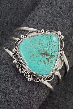 This stunning turquoise and sterling silver bracelet was made by Navajo silversmith Leslie Nez. The back is signed Leslie Nez and Sterling.Size: 5 5/8" (will fit up to a 6 7/8" wrist)Gap: 1 1/4"Width: 2 1/4"Free shipping on all orders! We ship with USPS and always include tracking. All orders ship within a day of payment.Returns are accepted up to 30 days after you receive your order. Just send us a message. Our shop offers cash back or store credit. The item must be returned in new condition. Elegant Sterling Silver Bracelet With Turquoise, Southwestern Turquoise Sterling Silver Cuff Bracelet, Handmade Turquoise Sterling Silver Southwestern Bracelet, Sterling Silver Bracelet, Native American Jewelry, Turquoise Sterling Silver, Free Jewelry, Sterling Silver Bracelets, Silver Bracelet