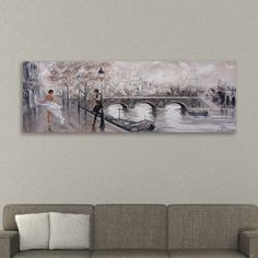 a painting hanging on the wall above a couch in a living room with a sofa