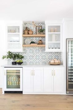 a kitchen with white cabinets and open shelves