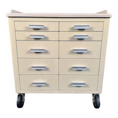 a white cabinet with many drawers on wheels