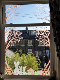 an open window with the view of houses outside