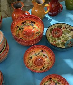 colorful bowls and plates on a blue table cloth