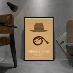 an indiana jones movie poster hanging on the wall next to a chair and table with a lamp