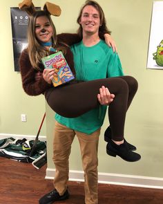 a man and woman dressed up as characters from the spongebob movie holding a book