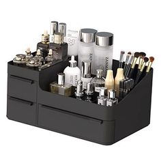 a black container filled with lots of different types of makeup brushes and other cosmetic items