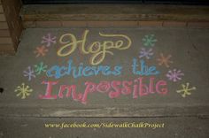 a sidewalk with chalk writing on it that says hope achieve the impossiblely written in multicolored letters