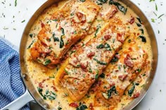 chicken parmesan in a skillet with cheese and spinach on the side