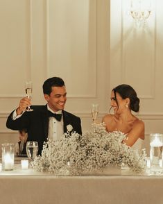 a bride and groom toasting at their wedding reception