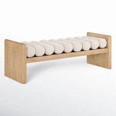 a wooden bench with six white pillows on the bottom and one is made out of wood