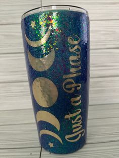 a blue and gold tumbler with the words, i love you to the moon and back