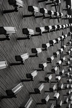 black and white photograph of rows of benches on the side of a building