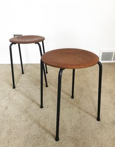 two wooden tables sitting on top of a carpeted floor