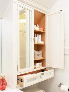 a bathroom with a sink, toilet and medicine cabinet