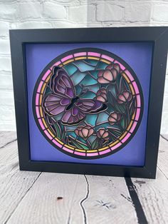 an image of a stained glass window with flowers in the center on a wooden table