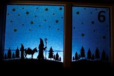 a silhouette of a wizard on a horse in front of a window