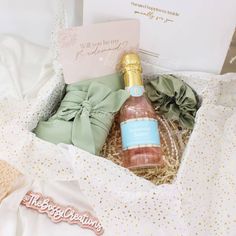 an open gift box containing a bottle of champagne