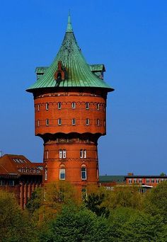 a tall brick tower with a green roof