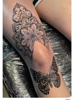 a woman's leg with a butterfly and flower tattoo on the side of her leg