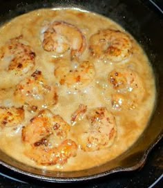 some food is cooking in a skillet on top of the stove burners,