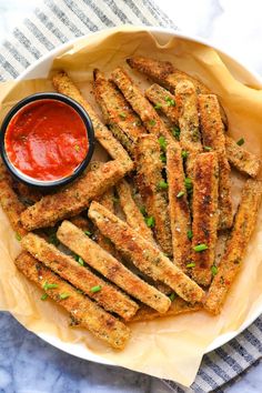 some fried food is on a plate with ketchup