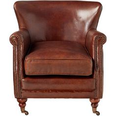 a brown leather chair sitting on top of a white floor