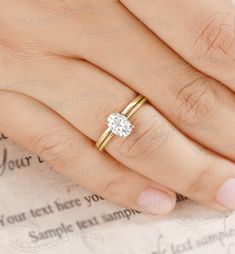 a woman's hand with a diamond ring on top of her finger and the word your text here written below it