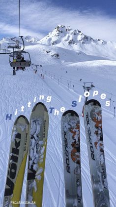 three skis are lined up in front of a chairlift on a snowy mountain