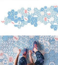 a person standing on top of a blue and white tile floor next to a wall