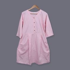 This casual linen dress is a versatile and laid-back garment that is perfect for everyday wear. Crafted from high-quality linen fabric, it offers a comfortable and breathable feel, making it ideal for warmer seasons. The dress features a relaxed fit with a slightly loose silhouette, allowing for ease of movement and a relaxed look, adding a touch of casual elegance to the overall design. The dress is available in various colours and sizes, allowing you to choose the one that suits your personal style. Whether you're running errands, meeting friends for brunch, or enjoying a day at the beach, this casual linen dress is a go-to option that combines comfort and style effortlessly. The natural fabric molds to your body shape and over time becomes softer. Please note that due to the many variat Button-up Linen Dress With Pockets, Pink Short-sleeved Linen Dress, White Linen Dress, Dress With Buttons, Dress With Short Sleeves, White Linen Dresses, Casual Elegance, Linen Clothes, Linen Dress