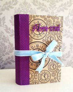 a purple book with a blue ribbon tied around it