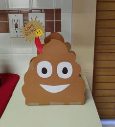 a paper cut out of a poop on top of a counter