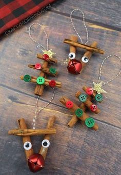 christmas ornaments made out of wooden sticks and buttons