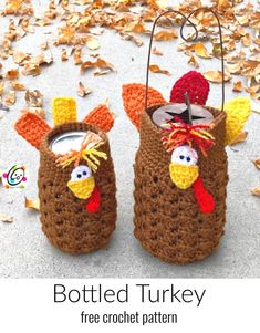 two crocheted turkey mug cozyies sitting next to each other on the ground