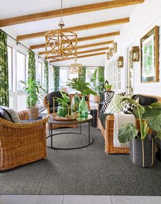 a living room filled with lots of furniture and plants