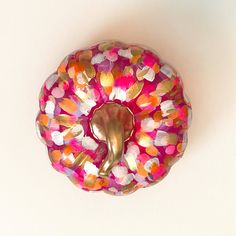 a pink donut covered in lots of colorful confetti