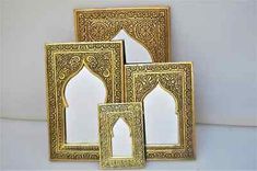 three gold frames with an intricate design on them