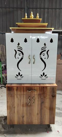 the cabinet is made out of wood and has two doors with designs on each side