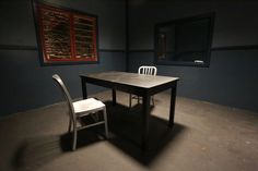 an empty room with a table and two chairs