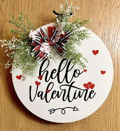 a sign that says hello valentine on the side of a wooden table with some flowers